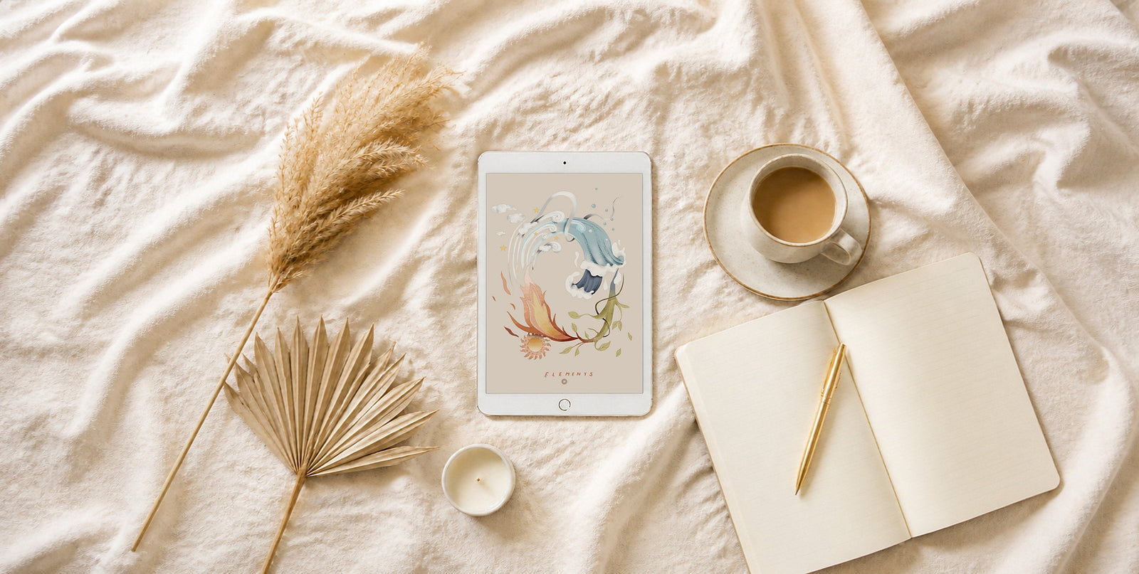 A white iPad showing an illustrated Guide from the Stars page on cream linen, with dried pampas grass and coffee